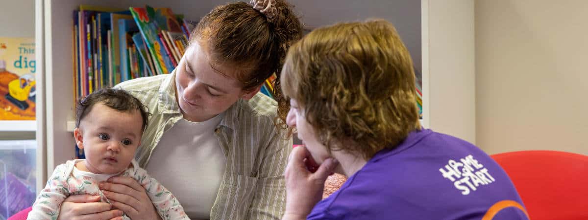 Image of Volunteer with mum and baby 