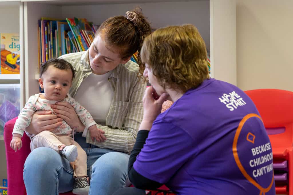 Image of Volunteer with mum and baby