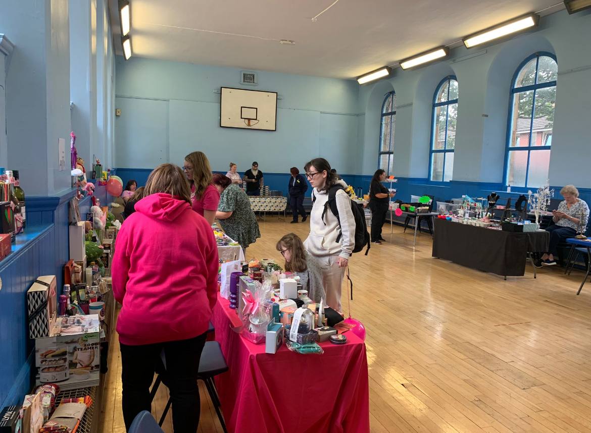 Image of stalls with people visiting to buy from them.
