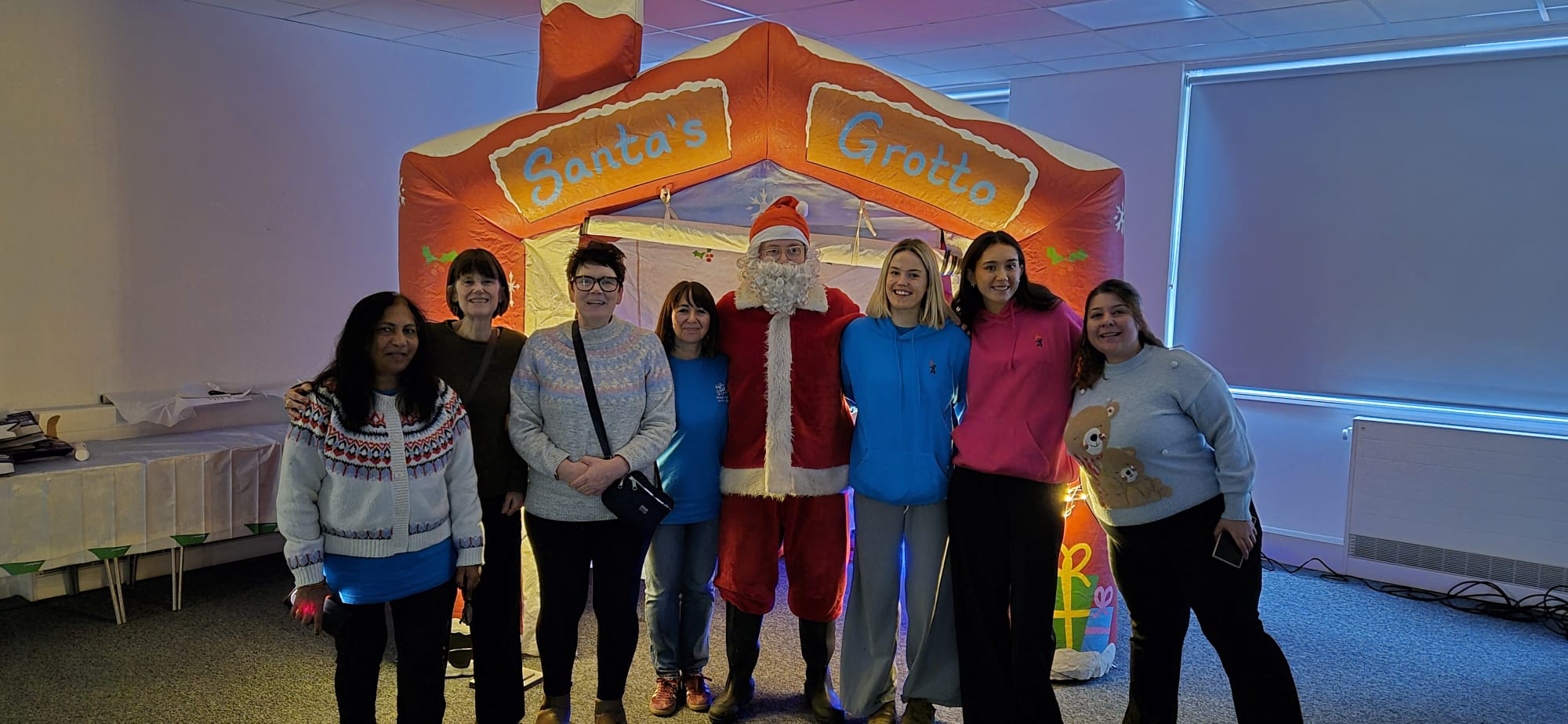 Image of Home-Start staff and volunteers with Santa at the Netherton Winterfest Event.