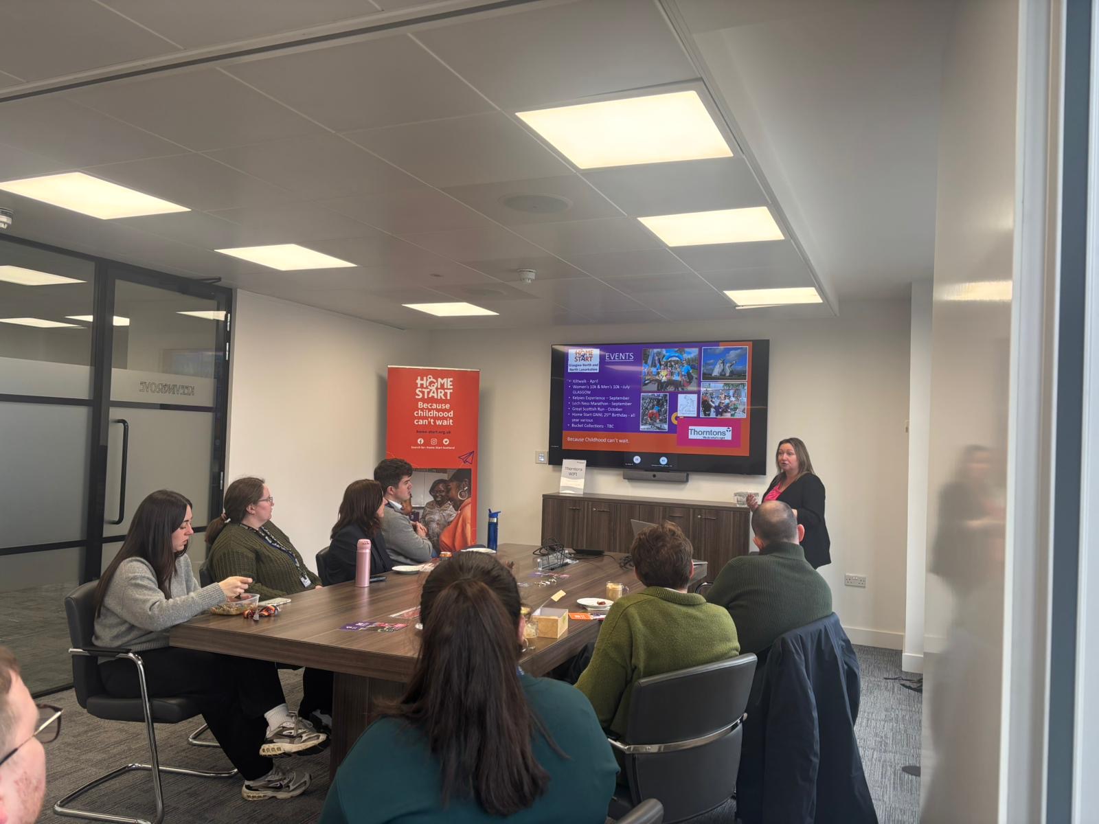 Image of Celia doing a presentation on Home-Start for Thorntons Law in their office.