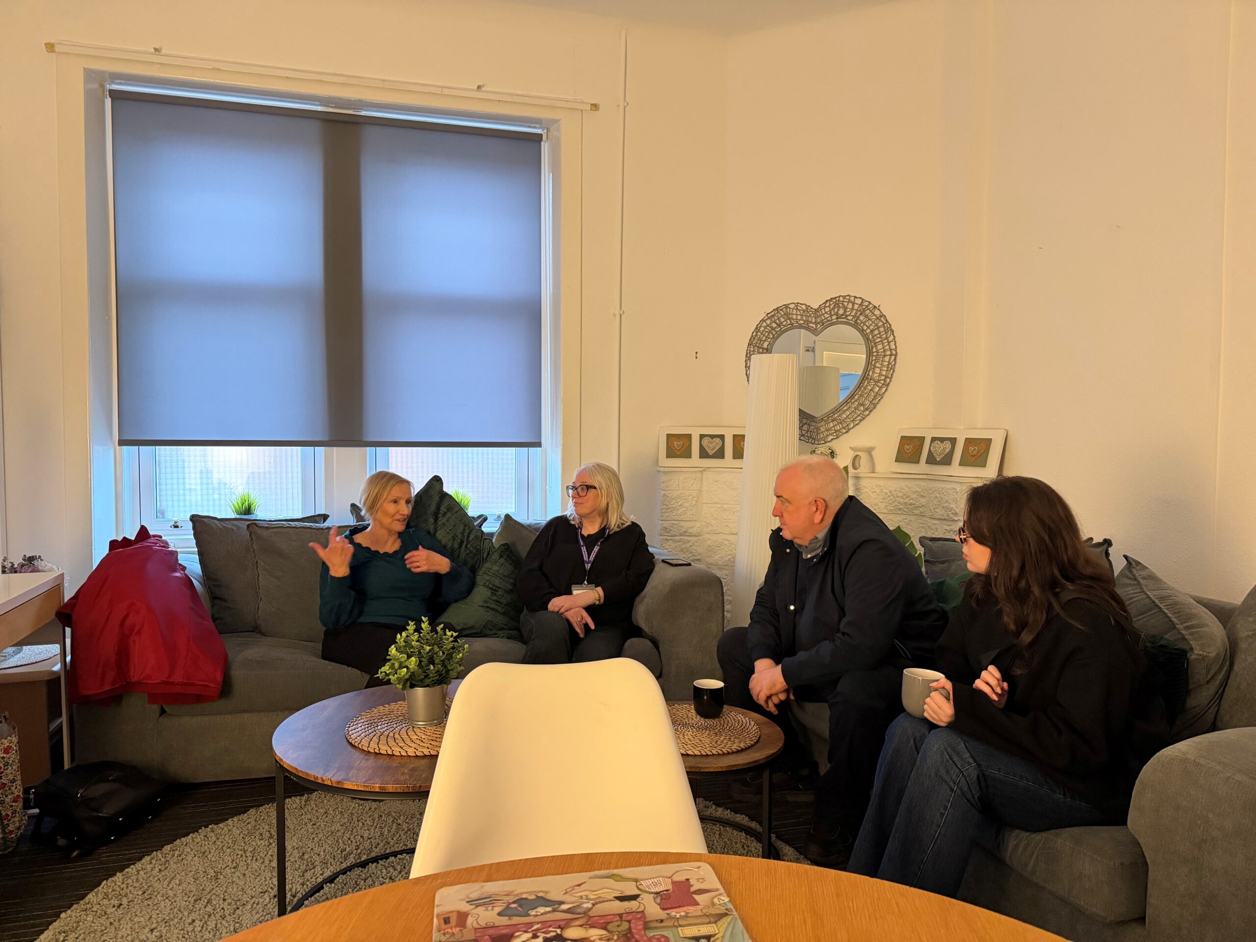 Image of Martin Rhodes at the hub sitting with some Home-Start Glasgow volunteers